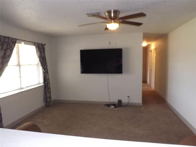 unfurnished living room with ceiling fan and carpet floors