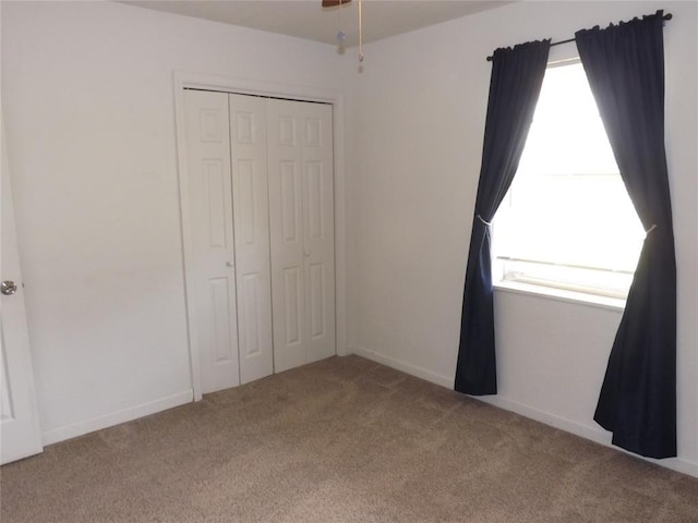 unfurnished bedroom featuring carpet and a closet