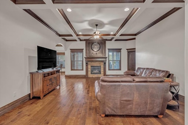 living room with ceiling fan, beam ceiling, wood-type flooring, and coffered ceiling