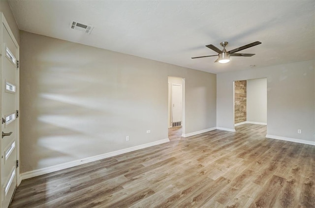 empty room featuring light wood-type flooring and ceiling fan