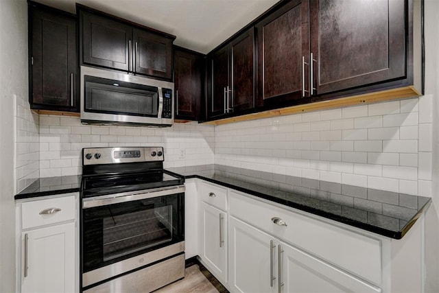 kitchen with tasteful backsplash, dark brown cabinets, white cabinets, and stainless steel appliances