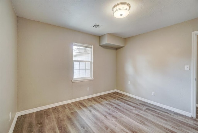 unfurnished room with light hardwood / wood-style flooring