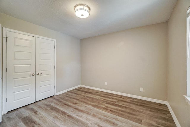 unfurnished room with light hardwood / wood-style floors