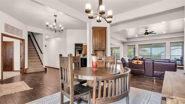 dining area with dark wood-type flooring and ceiling fan with notable chandelier