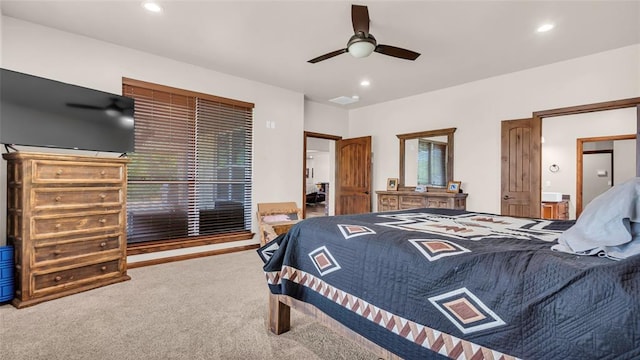 bedroom with ensuite bath, ceiling fan, and carpet