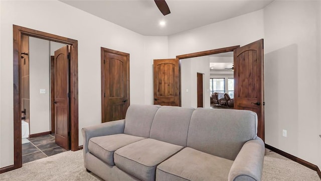 carpeted living room featuring ceiling fan