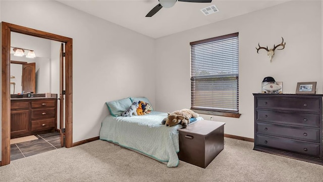 carpeted bedroom featuring connected bathroom and ceiling fan