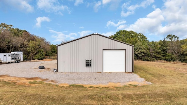 view of outbuilding featuring a lawn and a garage