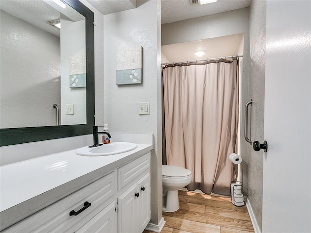 bathroom with vanity, curtained shower, toilet, and wood-type flooring