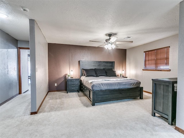 carpeted bedroom with a textured ceiling and ceiling fan