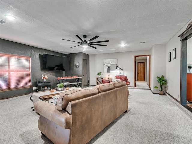 living room with light carpet, a textured ceiling, and ceiling fan