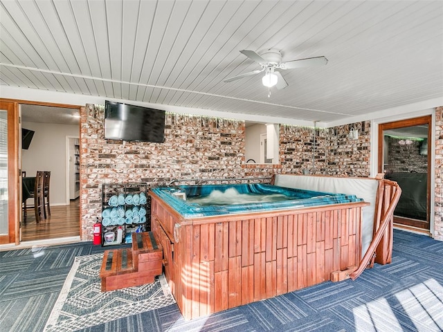 deck with ceiling fan and a hot tub