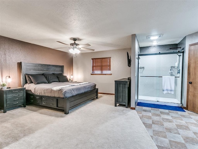 bedroom featuring ceiling fan, light carpet, and a textured ceiling