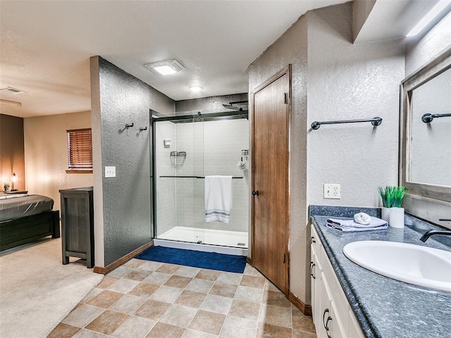 bathroom featuring vanity and an enclosed shower