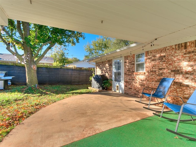 view of patio featuring a grill