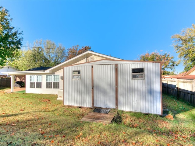 view of outbuilding with a yard