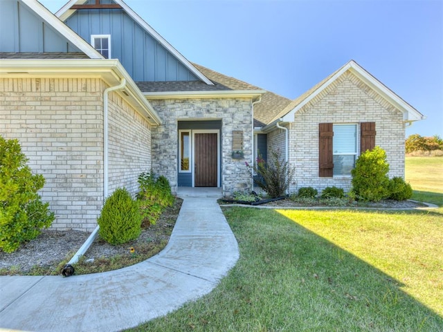 doorway to property with a lawn