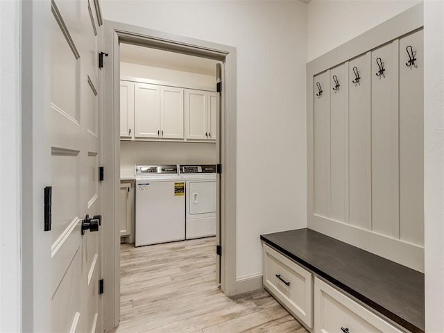 mudroom with light hardwood / wood-style flooring and washing machine and clothes dryer