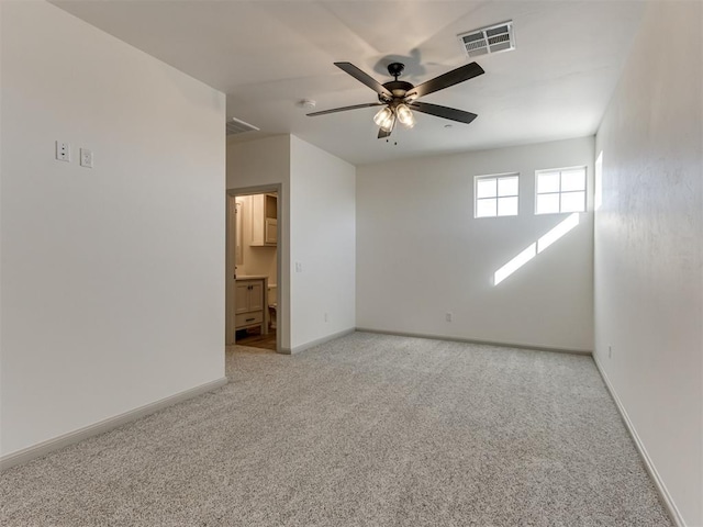 spare room featuring ceiling fan and light colored carpet