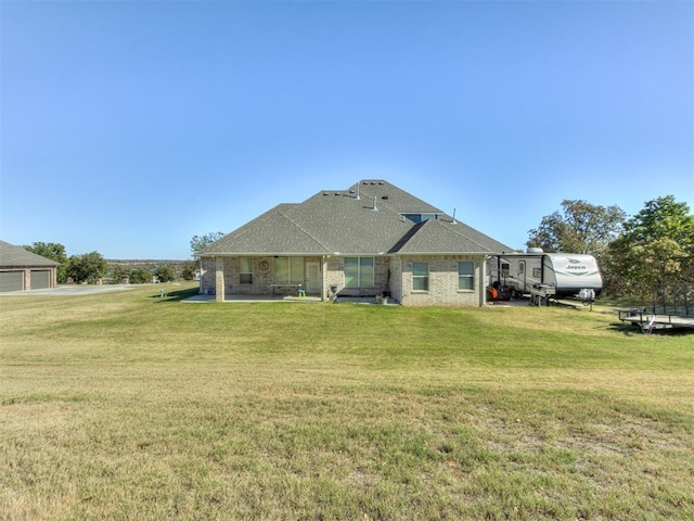 back of property featuring a yard and a patio