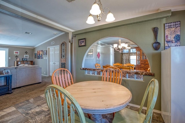 carpeted dining space with a healthy amount of sunlight, vaulted ceiling, and a chandelier