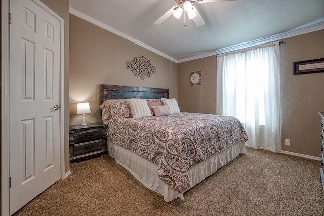 carpeted bedroom with ceiling fan and ornamental molding