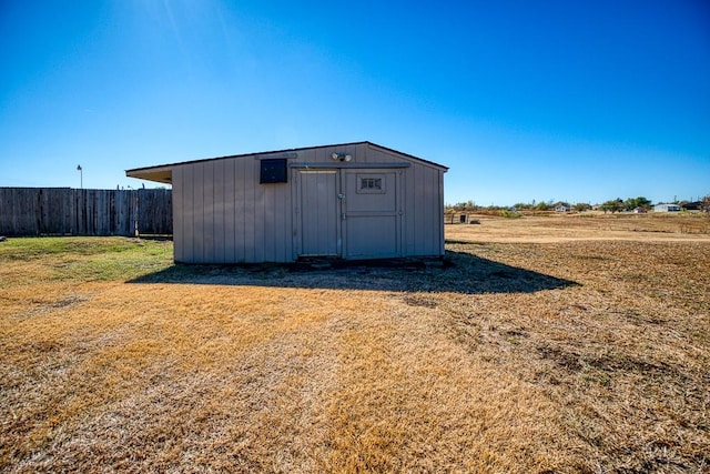 view of outdoor structure featuring a lawn