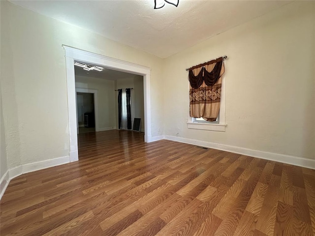 spare room with hardwood / wood-style flooring