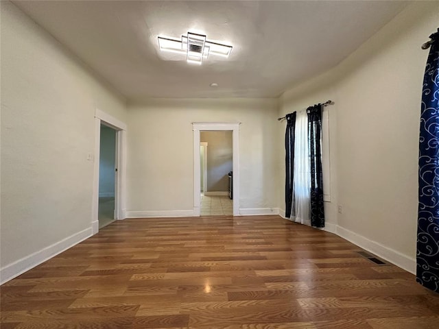 spare room with hardwood / wood-style floors