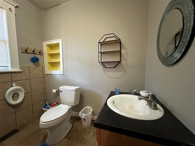 bathroom with tile patterned flooring, vanity, and toilet