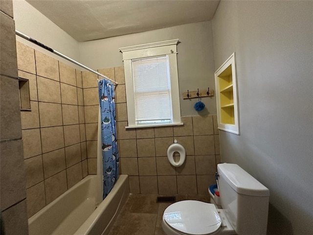 bathroom featuring tile patterned floors, shower / bath combination with curtain, toilet, and tile walls