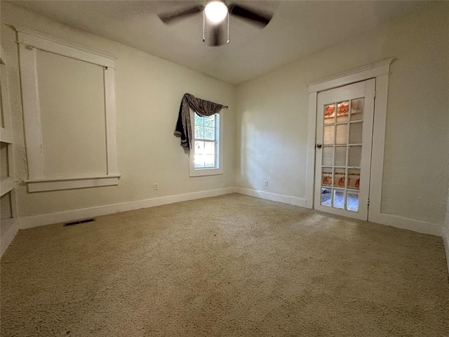 carpeted empty room featuring ceiling fan