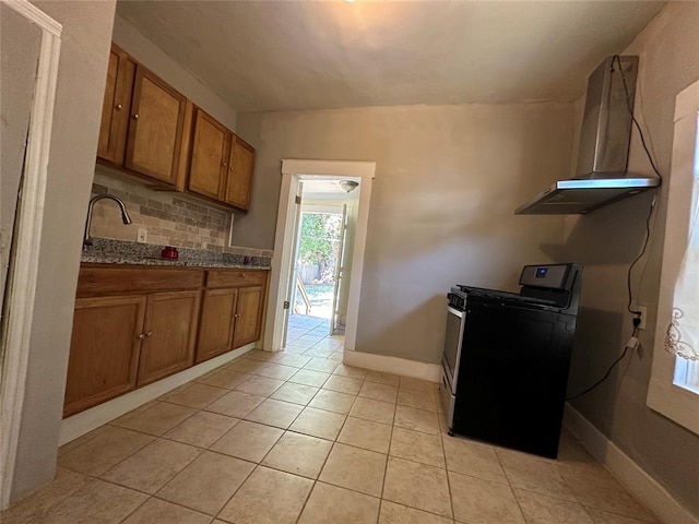 kitchen with sink, tasteful backsplash, black range with electric stovetop, and light tile patterned flooring