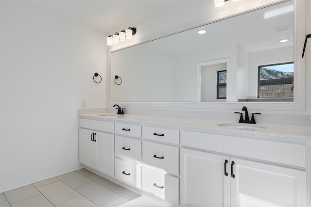 bathroom with tile patterned floors and vanity