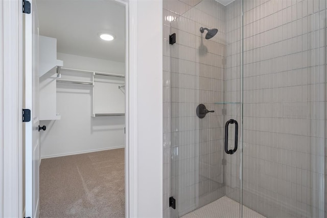 bathroom featuring a shower with shower door