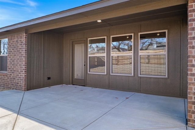 entrance to property with a patio