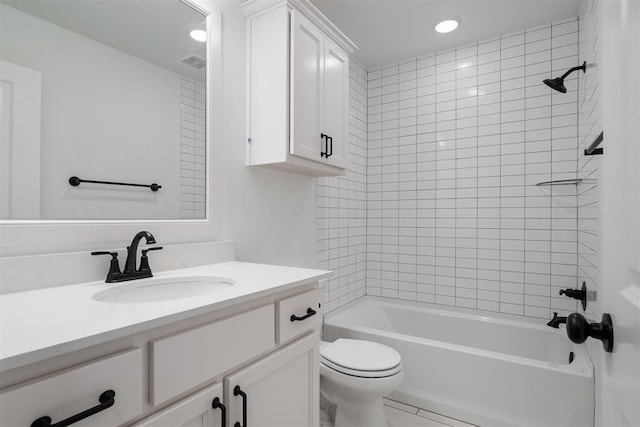 full bathroom featuring toilet, tiled shower / bath, and vanity