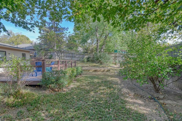 view of yard with a fenced backyard and a deck