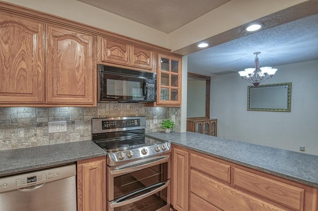 kitchen featuring stainless steel appliances, dark countertops, backsplash, brown cabinetry, and glass insert cabinets