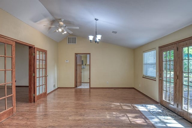 spare room featuring lofted ceiling, visible vents, wood finished floors, and french doors