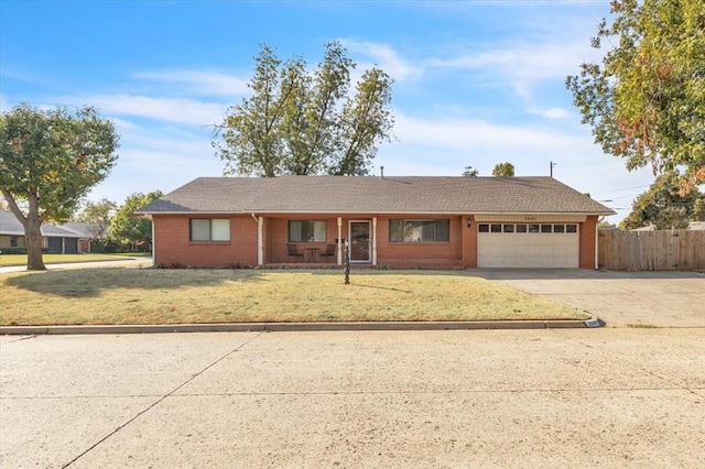 single story home with a front yard and a garage