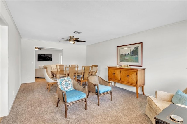 living area with light colored carpet and ceiling fan