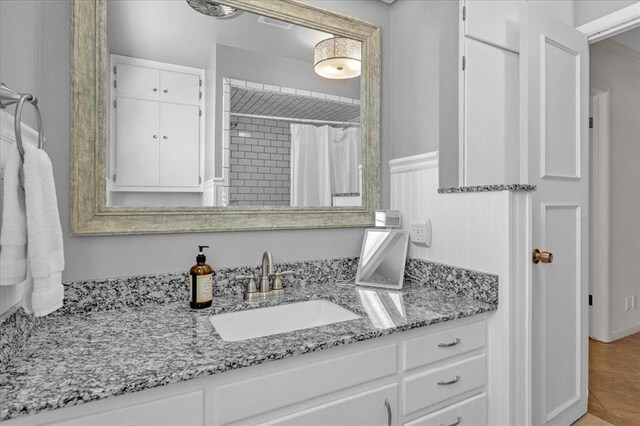 bathroom with tile patterned floors, vanity, and curtained shower