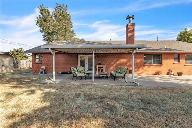 back of property featuring a patio area, a yard, and french doors