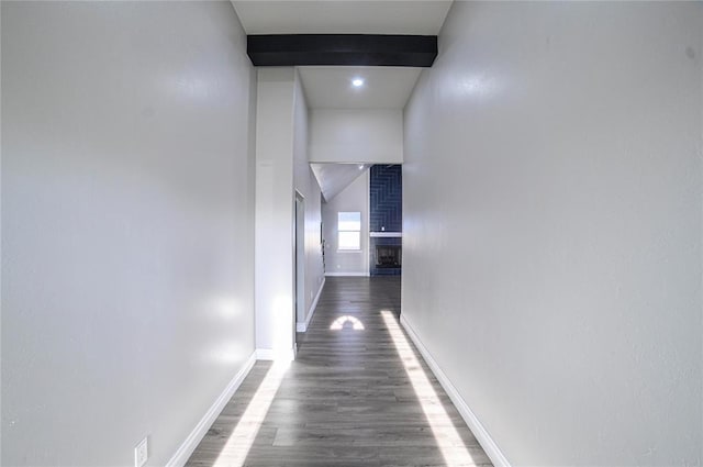 corridor with beamed ceiling and dark hardwood / wood-style floors