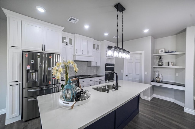 kitchen with white cabinetry, sink, decorative light fixtures, and appliances with stainless steel finishes