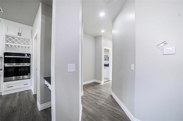 hallway featuring dark hardwood / wood-style flooring