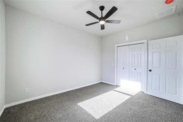 unfurnished bedroom featuring carpet, ceiling fan, and a closet