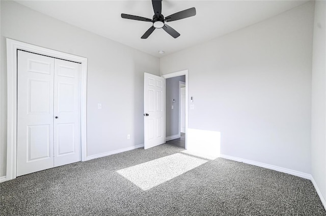 unfurnished bedroom with ceiling fan, a closet, and carpet floors