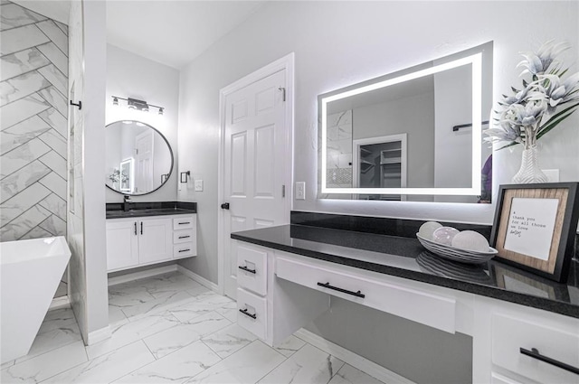 bathroom featuring vanity and a bath